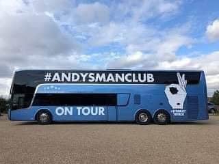 An Andy's Man Club tour bus