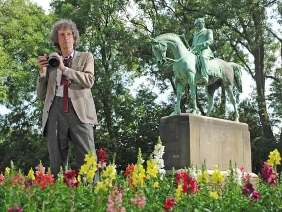 Vic Allen, who runs the galleries at Dean Clough in Halifax by a statue of Prince Albert in  Sparrow Park (also known as Albert Park), Halifax