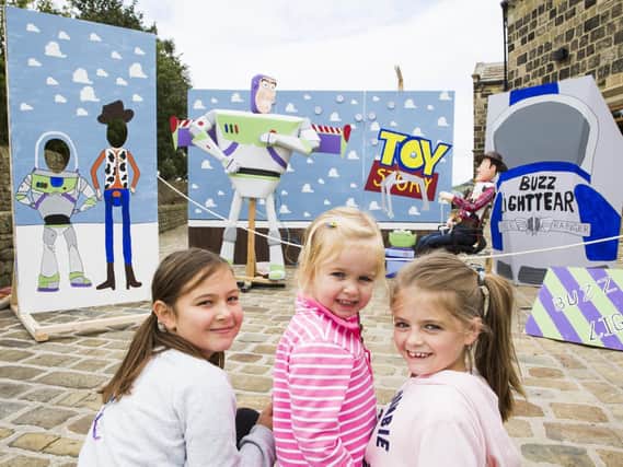 From the left, Daisy Didgiunaitis, 10, Charlotte Stanger, two, and Holly Stanger at an amazing Toy Story display.
