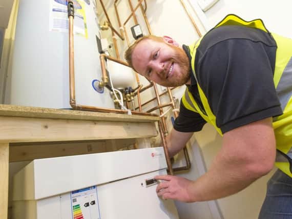 Jason Oakes, installing one of the new heating systems