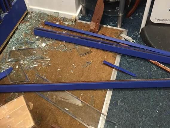 Some of the glass smashed by vandals at the charity shop in Elland.
