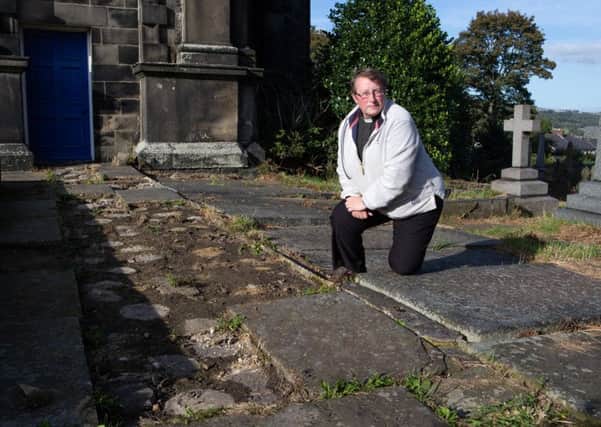 Reverend Jeanette Roberts disappointed after some old stone flags were stolen from St Peter's church, Sowerby
