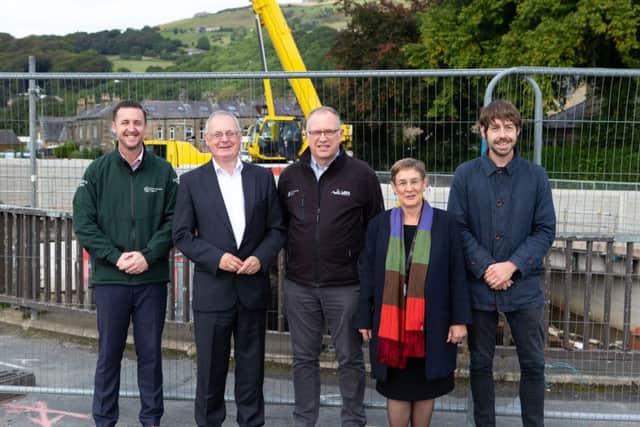 Paul Swales from the Environment Agency, Calderdale Council leader Tim Swift, Chris Blenkarn - main contractor VBA, coun Jane Scullion - deputy leader and coun Scott Patient - representative for Climate Change and the Environment, on Caldene Bridge, Mytholmroyd