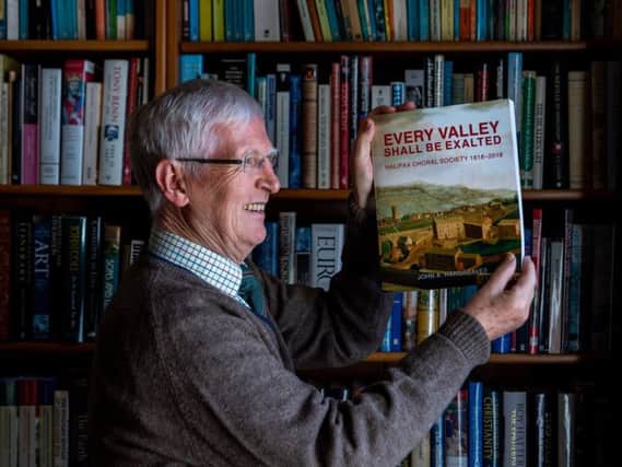 Dr John Hargreaves, with his book on Halifax Choral Society.