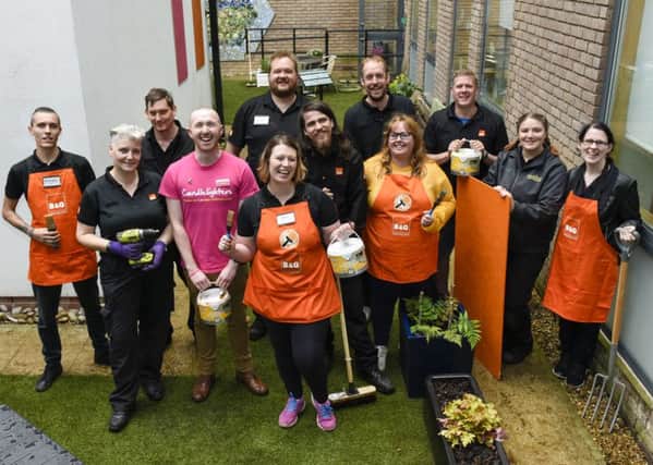 Spruce up: The B&Q team brightened up a garden for Candlelighters.