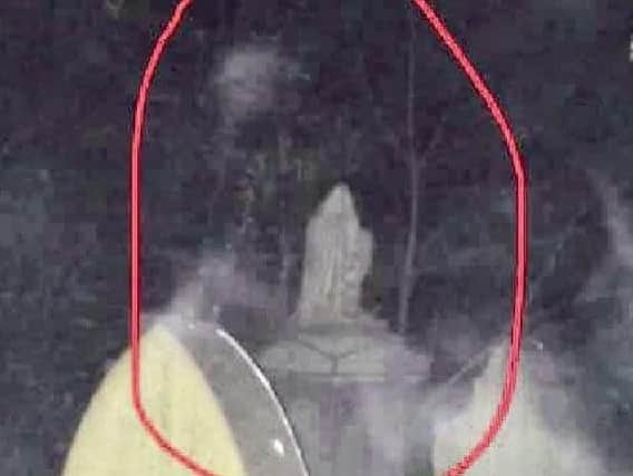 A photo of the mysterious sighting in the graveyard at Todmorden Unitarian Church - Rob has circled the figure in red