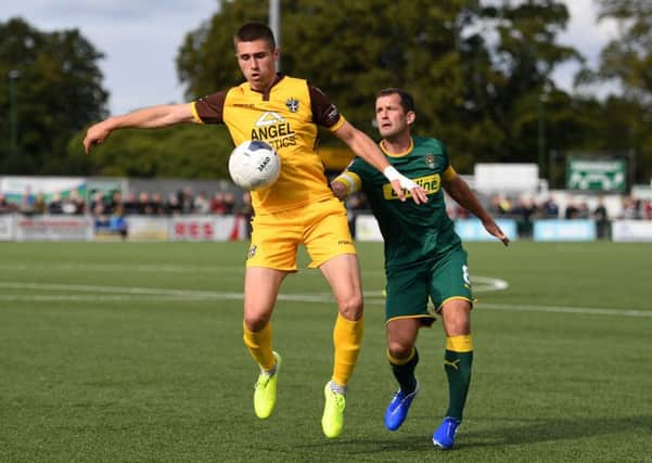 SUTTON, GREATER LONDON - SEPTEMBER 07: Aaron Jarvis of Sutton United controls the ball under pressure from Michael Doyle of Notts County during the Vanarama National League match between Sutton United and Notts County at Knights Community Stadium on September 07, 2019 in Sutton, Greater London. (Photo by Harriet Lander/Getty Images)