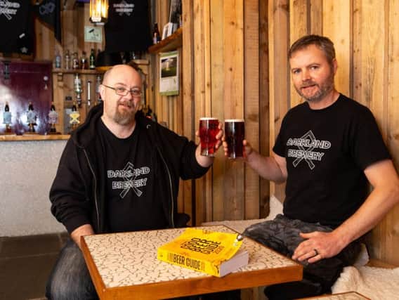 Jonny Mountain and Gav Riach, with the Good Beer Guide 2020, in the Pallet Bar, at Darkland Brewery, Ladyship Mills Business Park, Halifax.