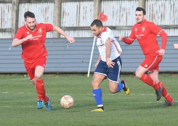 Bridlington Town's Chris Jenkinson and Jack Griffin closing in on Yorkshire Amateur's Ashley Flynn