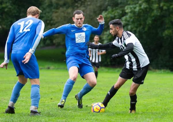 Actions from the game, Hollins Holme v FC Panda. Pictured is Richard Laycock and Tariq Pervez