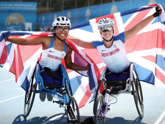 Hannah Cockroft, right, and Kare Adenegan, left, celebrate finishing first and second in the women's 800m T34 final. (Photo by Bryn Lennon/Getty Images)