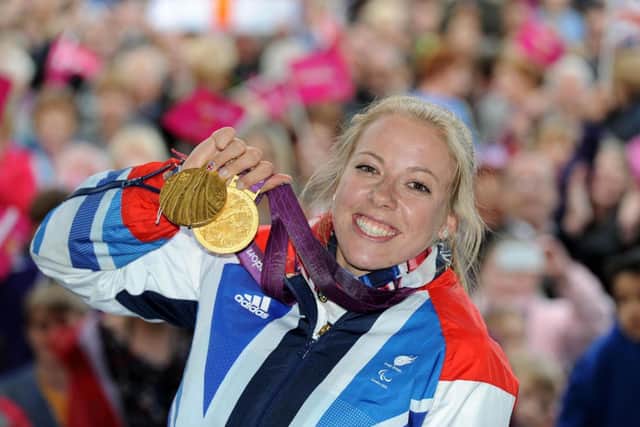 Double Paralympics gold medallist Hannah Cockroft holds up her medals at the Piece Hall in her home town of Halifax, West Yorkshire, during civic reception in her honour.
Picture taken on Thursday 13 September 2012