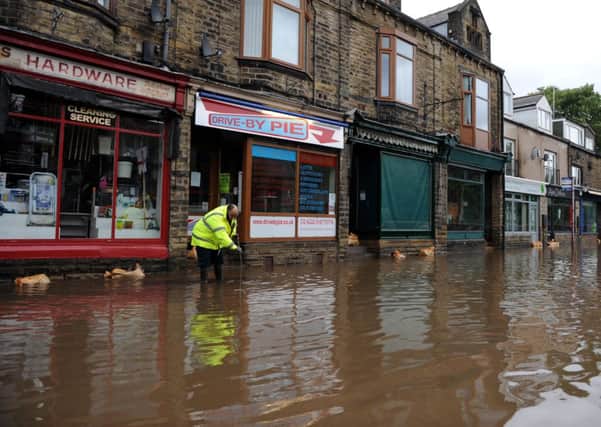 Floodwaters surrounds local shops in the centre of Mytholmroyd during the floods of 2012