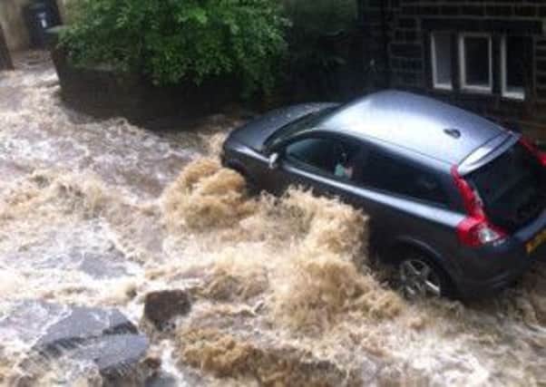Flood water flows towards Walsden station - photographed by Jamie Stuttard