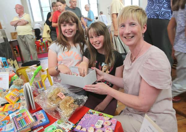 Charity Jigsaw Festival at St Martin's Parish Church, Brighouse.
From the left, Eleanor Craven, left, and Rebecca Kirby, centre, try their luck with the tombola.