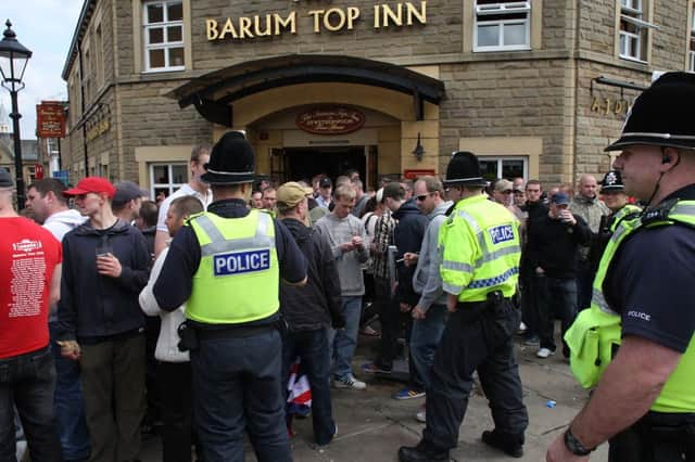 Police  contol the EDL at The Barum Top Inn, Halifax.