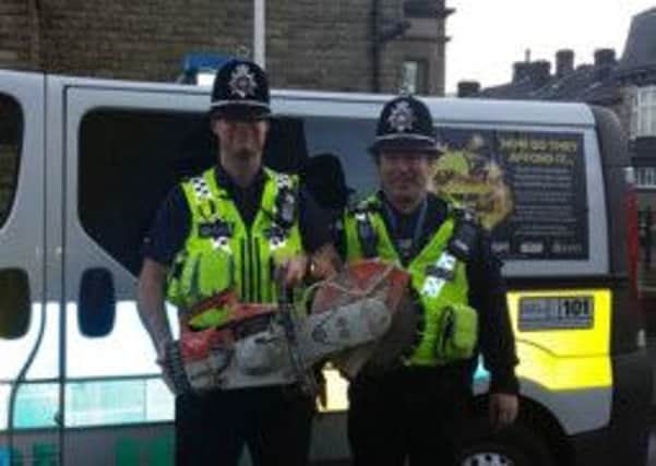 PC Phil Eastwood and Sergeant Michael Bowden with the saw which has been found six years after it was stolen