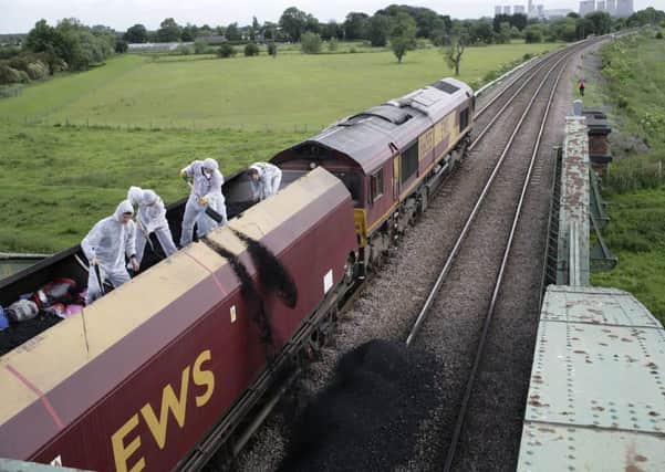 A train carrying over 1000 tonnes of coal, halted over a bridge on it's way to Drax power station near Selby, West Yorkshire, UK.
Activists who stopped the train with a red flag, then climbed on top and proceeded to shovel coal onto the tracks. They protest against the Drax's continuing role as the largest signle polluter in the UK and producer of over twenty (20) million tonnes of CO2 every year.
The 35 protestors planned to stay in occupation of the train.
© Nick Cobbing
13 June 2008
07973 642 103
nick@nickcobbing.co.uk