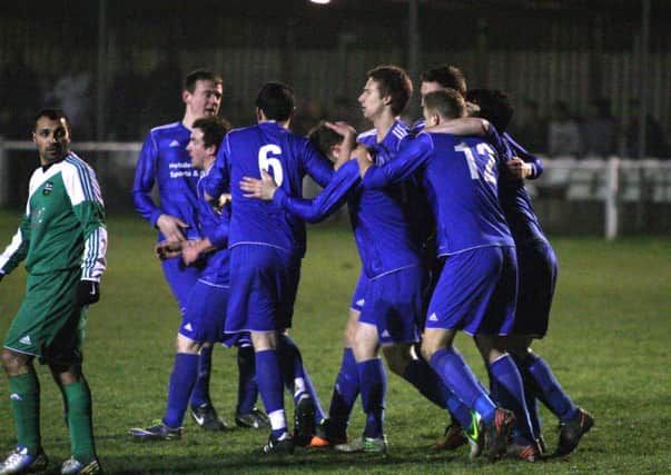 Hollins Holme celebrate their opening goal from Spencer Harris