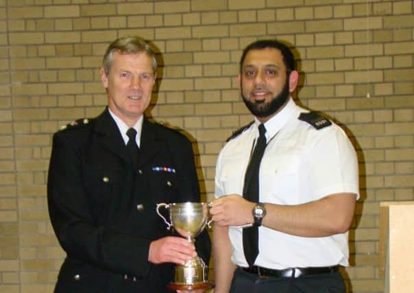 Acting section officer Omer Ayub (right) has been recognised for his outstanding work in the community