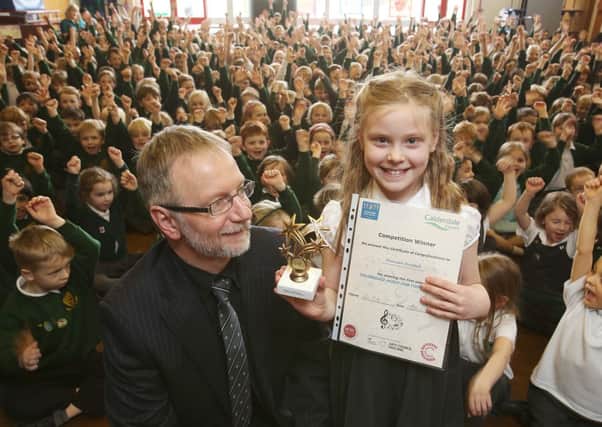 Head of music service Kevin Rivett with winner of the Calderdale Music Hub competition Hannah Horsfall, seven, at Lightcliffe CE Primary School.
