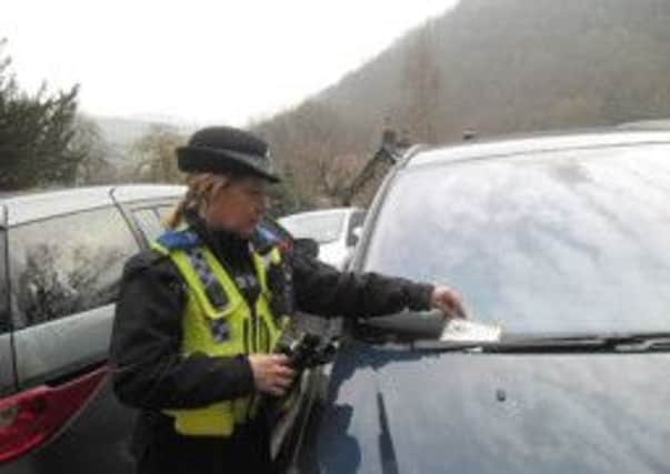 Pictured is PCSO Judith Wood at Hardcastle Crags distributing vehicle safety leaflets