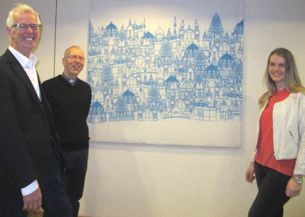 With the new hospital wall hangings are Dharmachari Prasadu, Ordained member of the Triratna Buddhist Order, George Spencer, Chaplaincy Co-ordinator and Cecilia Erlandsson from The University of Huddersfield.