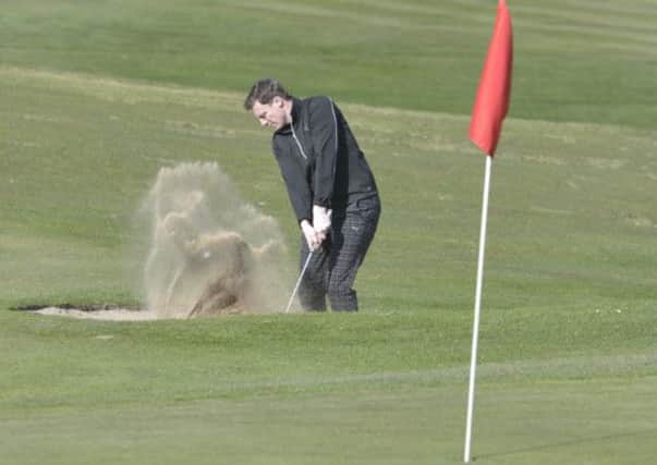Bradley Park's Tom Wild plays out of a bunker yesterday