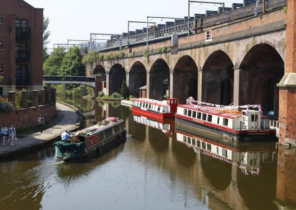 Canal barges make their way along the Manchester Ship Canal  in Manchester city centre as the warm weather continues across the UK. PRESS ASSOCIATION Photo. Picture date: Wednesday May 23, 2012. Photo credit should read: Dave Thompson/PA Wire
