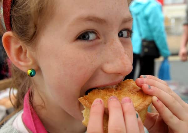 Ten-year-old Alice Akerman samples the pies at Brighouse Food Festival.