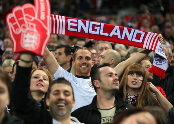 England fans cheer on their side in the stands during the FIFA 2014 World Cup Qualifying Campaign