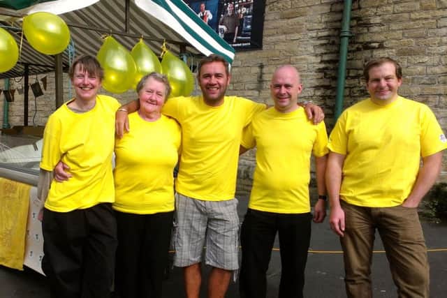 Todmorden Market traders get ready to greet people coming to watch the Tour De France on the big screen at Bramsche Square, Todmorden, Sunday, July 6, 2014