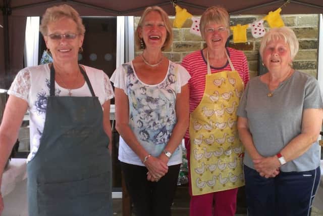 Members of St Michael's Church group sell hot food, cakes, coffees and teas to raise funds for the church