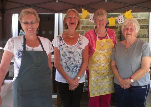 Members of St Michael's Church group sell hot food, cakes, coffees and teas to raise funds for the church