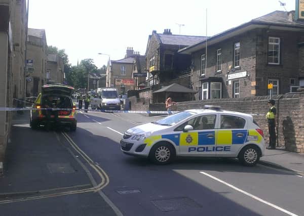 Police at the scene of the public distrurbance on Hopwood Lane, Halifax. Two men have now been charged with wounding