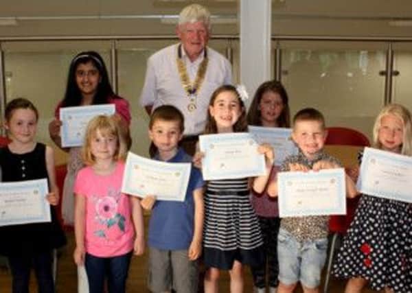 President Jim Walker of Halifax Calder Rotary club with some of the competition winners for the club's Tour De France colouring competition.