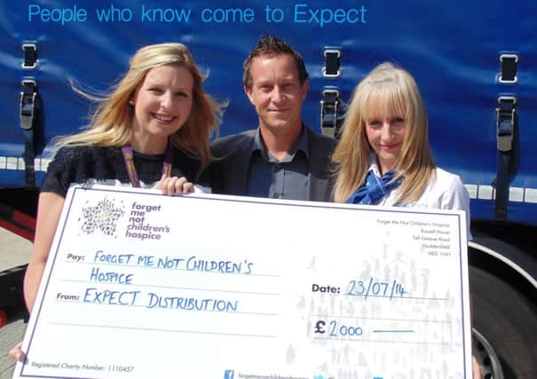 Kate Goldring, senior corporate partnership manager for the Forget Me Not Children's Hospice, receives the cheque from Expect Distribution Managing Director Neil Rushworth and sales and marketing executive Gemma Bentley.