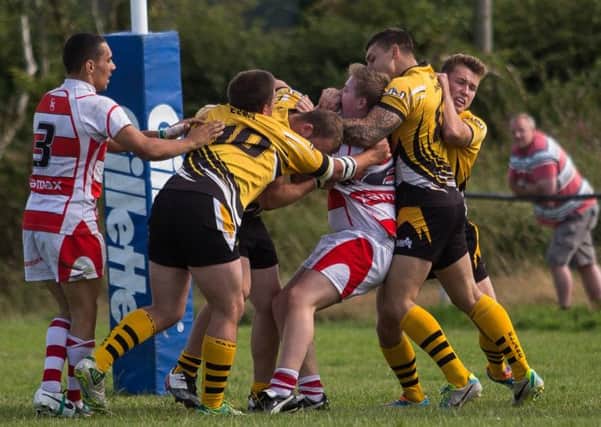 Strong tackling from Elland (yellow) against Ovenden yesterday