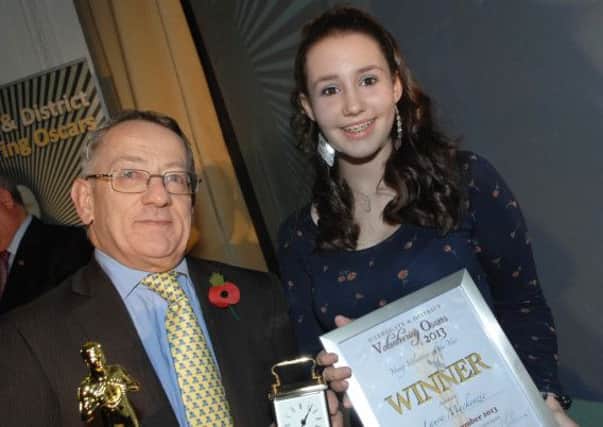 Philip Broadbank of Enid Taylor Ltd presents Laura Mckenzie with her Young Volunteer of the Year Award in 2013. (1311011AM10)
