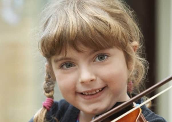 Young Girl Learning To Play Violin