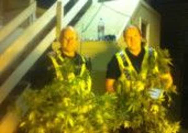 PCSO Dave Evans (left) and Acting Sergeant Ryan Stockton with drugs uncovered during a raid on a Todmorden comercial unit