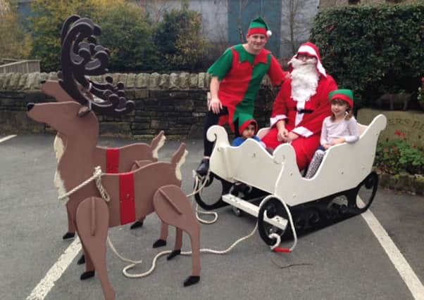 Santa and his helper arrive at Waters Edge playgym, Elland, much to the delight of Jayden Jairath and Jessica Woodward
