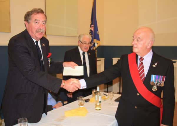 David Woolley, presenting a cheque to the Huddersfield and District Army Veterans at their annual dinner.