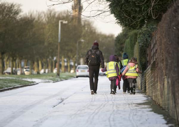 Children walk through the snow to get to school, Savile Park, Halifax.
