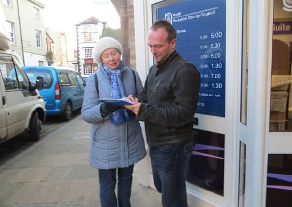 A volunteer gathers signatures for the 'Save Knaresborough Library' petition.