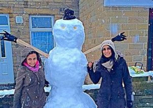 Asima Begum with her daughter Aysha Mahmood with their impressive snowman