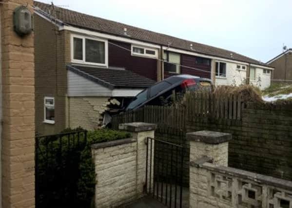 A black Audi A3 went into a house on  Summerfield Road, Todmorden