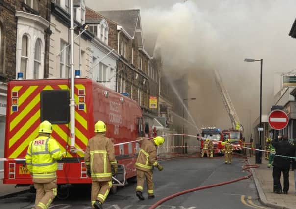 Firefighters battle the blaze on Albert Street. Picture : Adrian Murray. (1403181AM14)