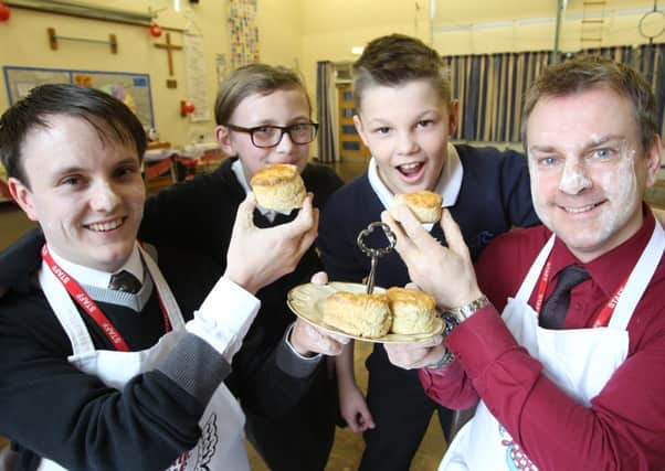 Comic Relief Bake Off at St John's Primary Academy, Clifton. Teachers Karl Roberts and Simon Bedford with pupils Eloise Morrisrow 11 and Harrison Povey 10.