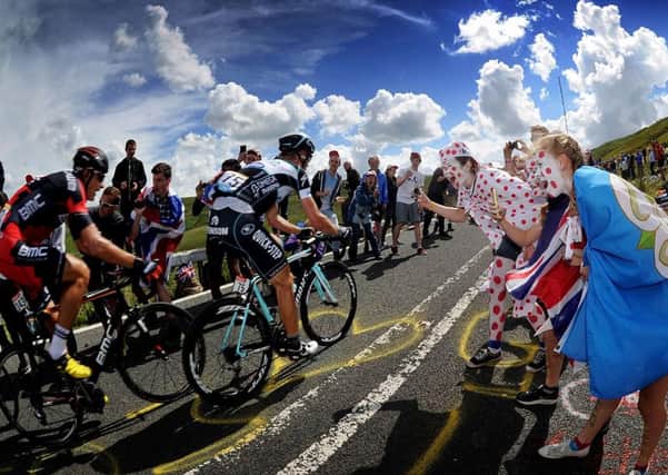 Fans Cheer on cyclists as they tackle the Holme Moss climb on the Tour de France Stage 2..6th July 2014 ..Picture by Simon Hulme